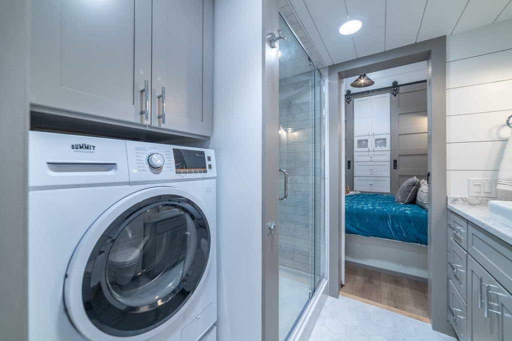 Washer dryer combination unit in white by shower