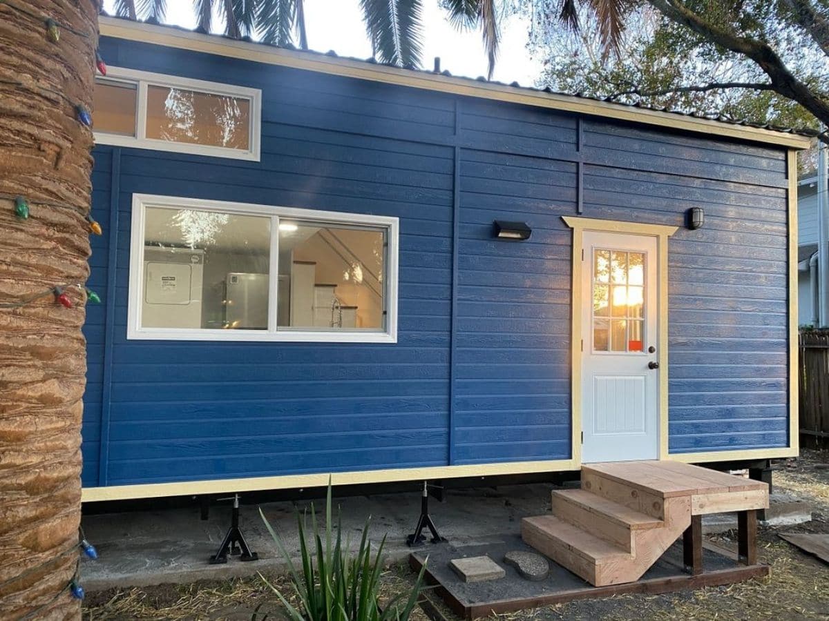 blue tiny house with white front door