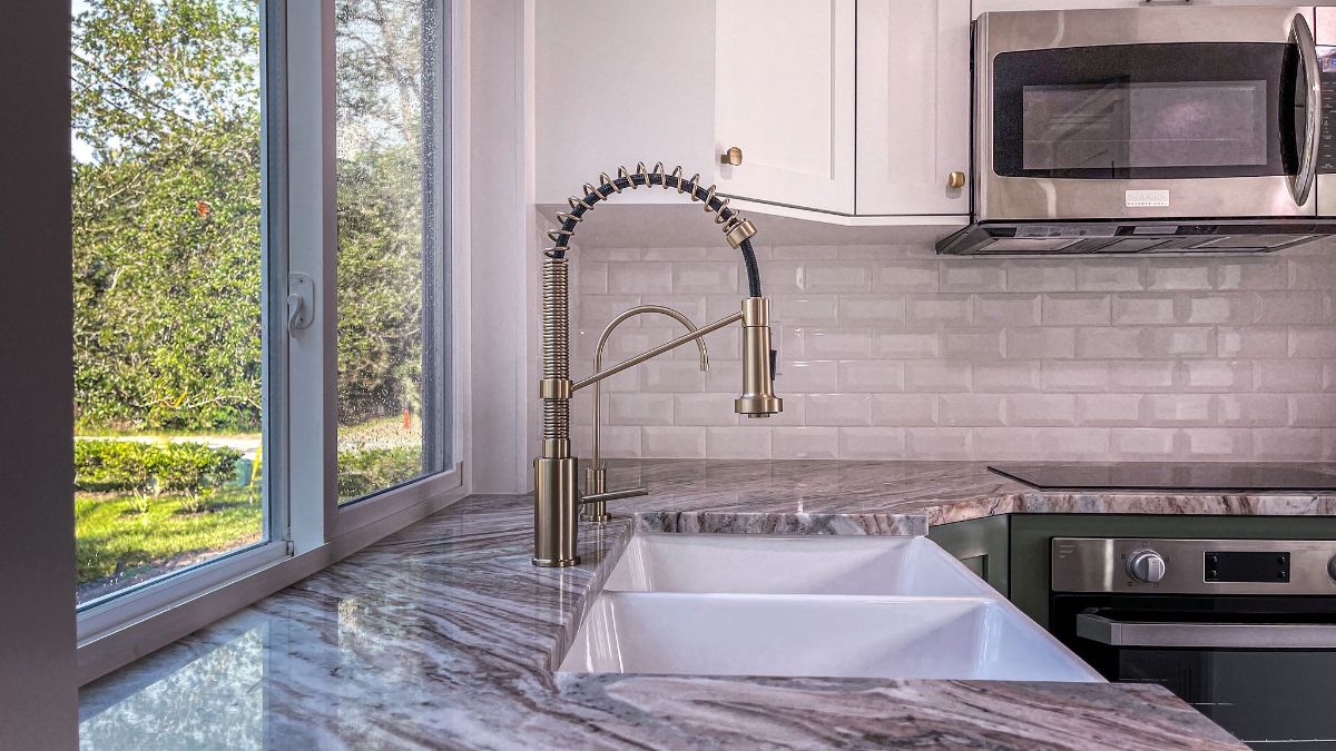 stainless steel faucet on sink with marble counter