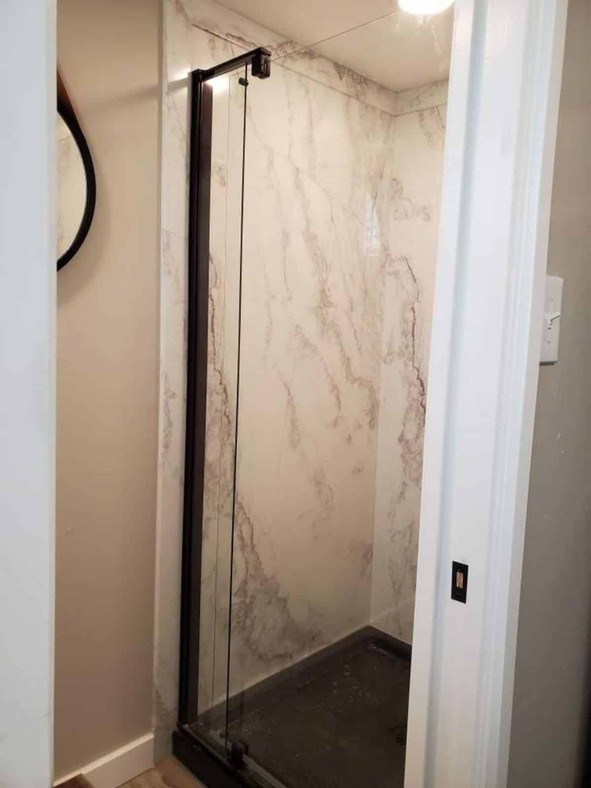 full length shower area with glass enclosure