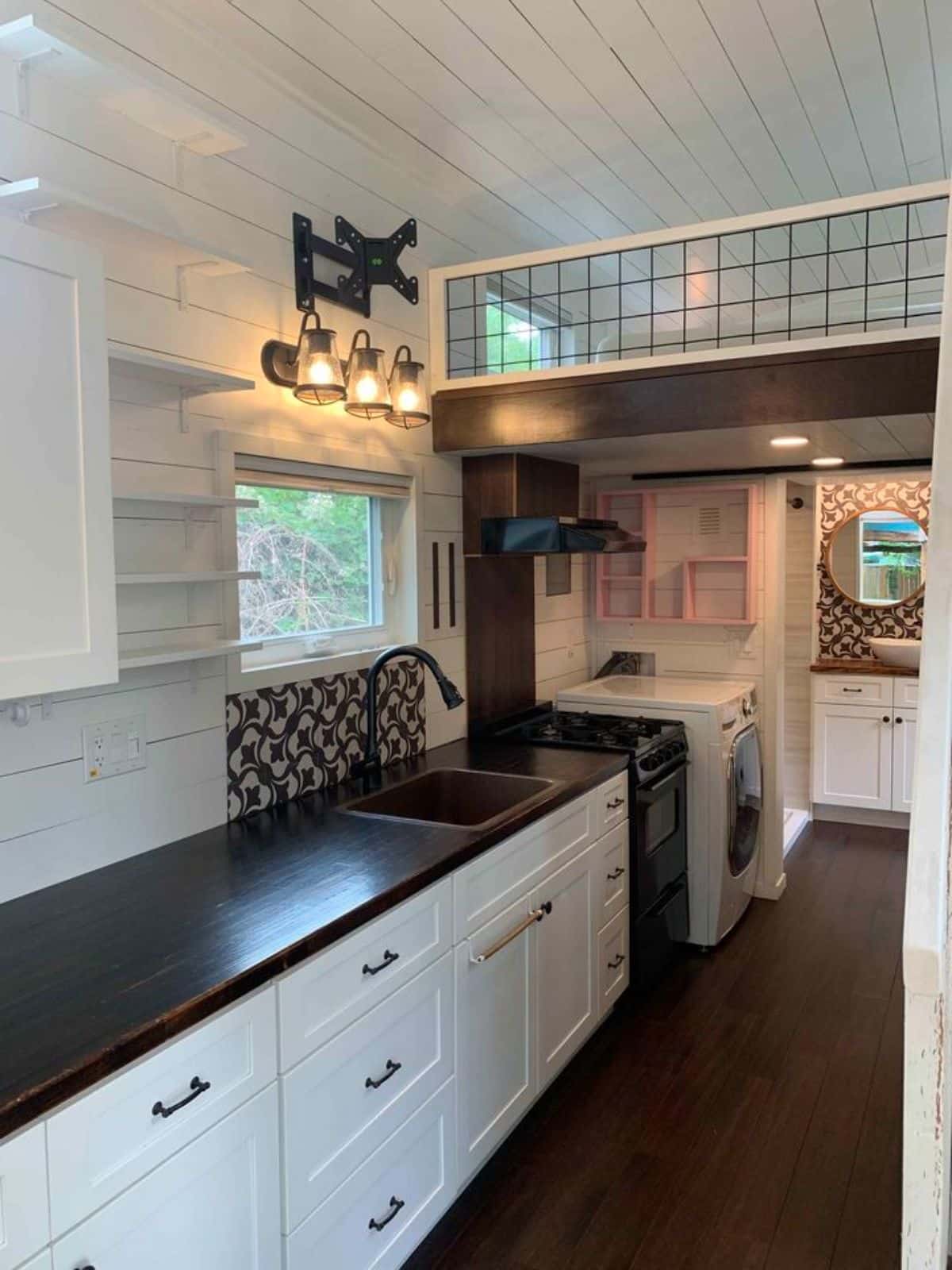 huge kitchen countertop with all the essential appliances and storage cabinets